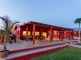 the bright and charming lodge welcomes guests with spectacular sunsets